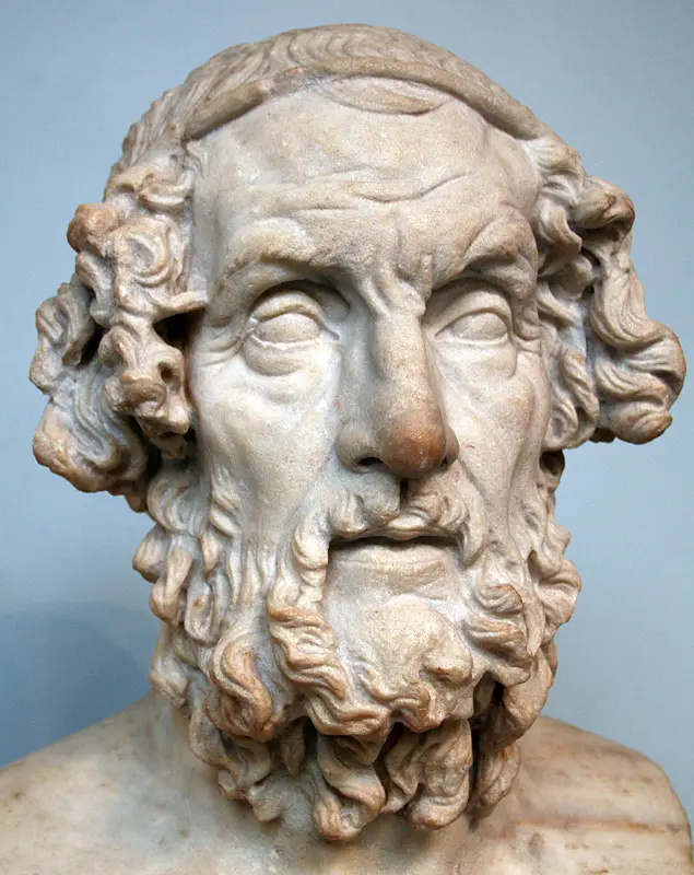 Busto de mármore de um homem idoso de barba longa e olhos fechados, a imagem tradicional do poeta cego.